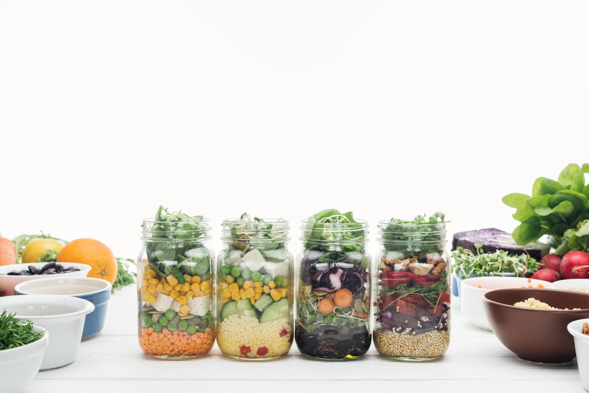Stack of lunch-ready jars with salads